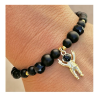 Bracelet perles onyx, pendentif astronaute